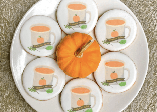 A plate of cookies with pumpkin on top.